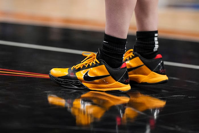 View of Caitlin Clark's black and gold Nike Kobe shoes.
